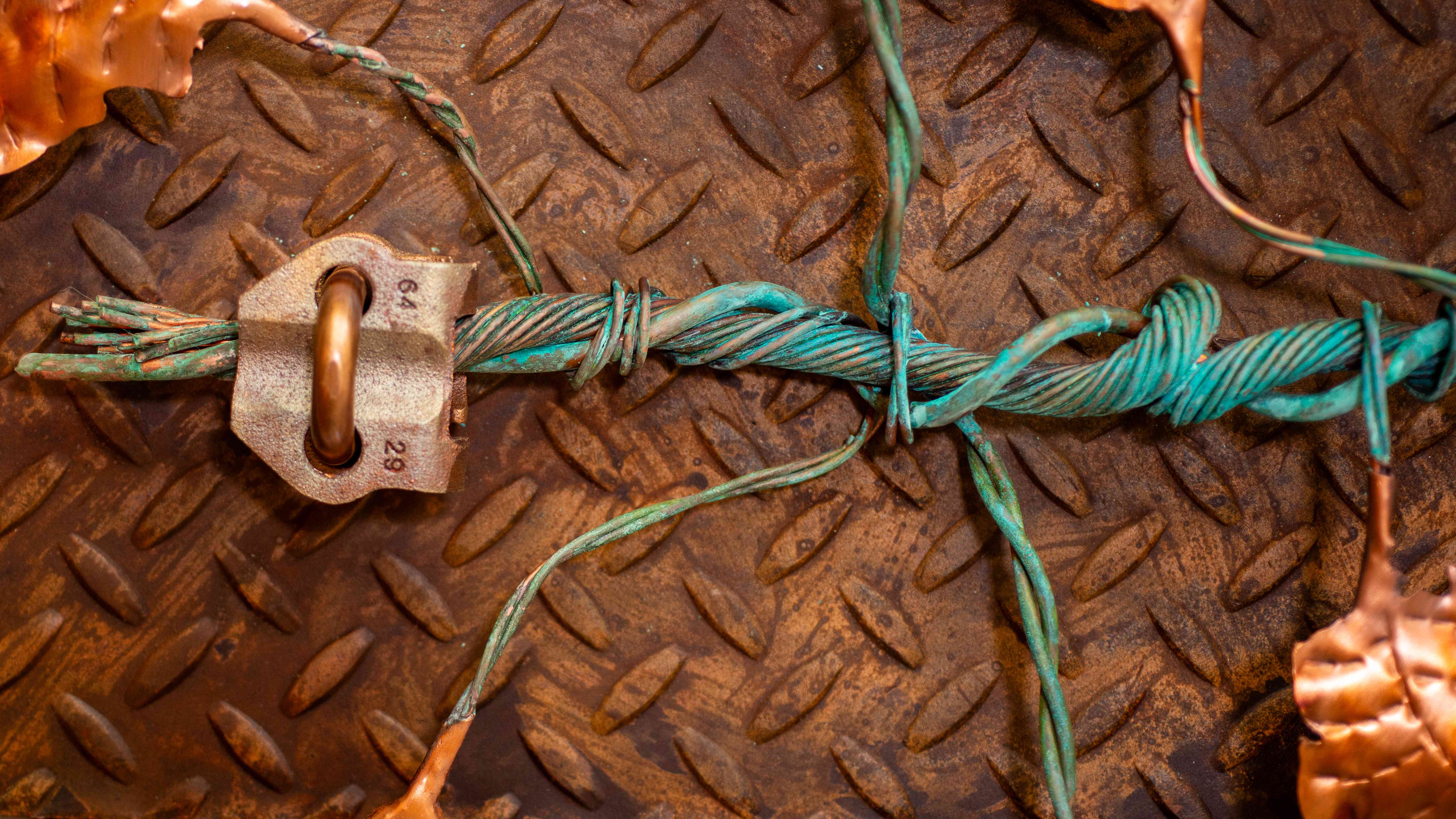 Diamond plate steel with green rope and copper accents