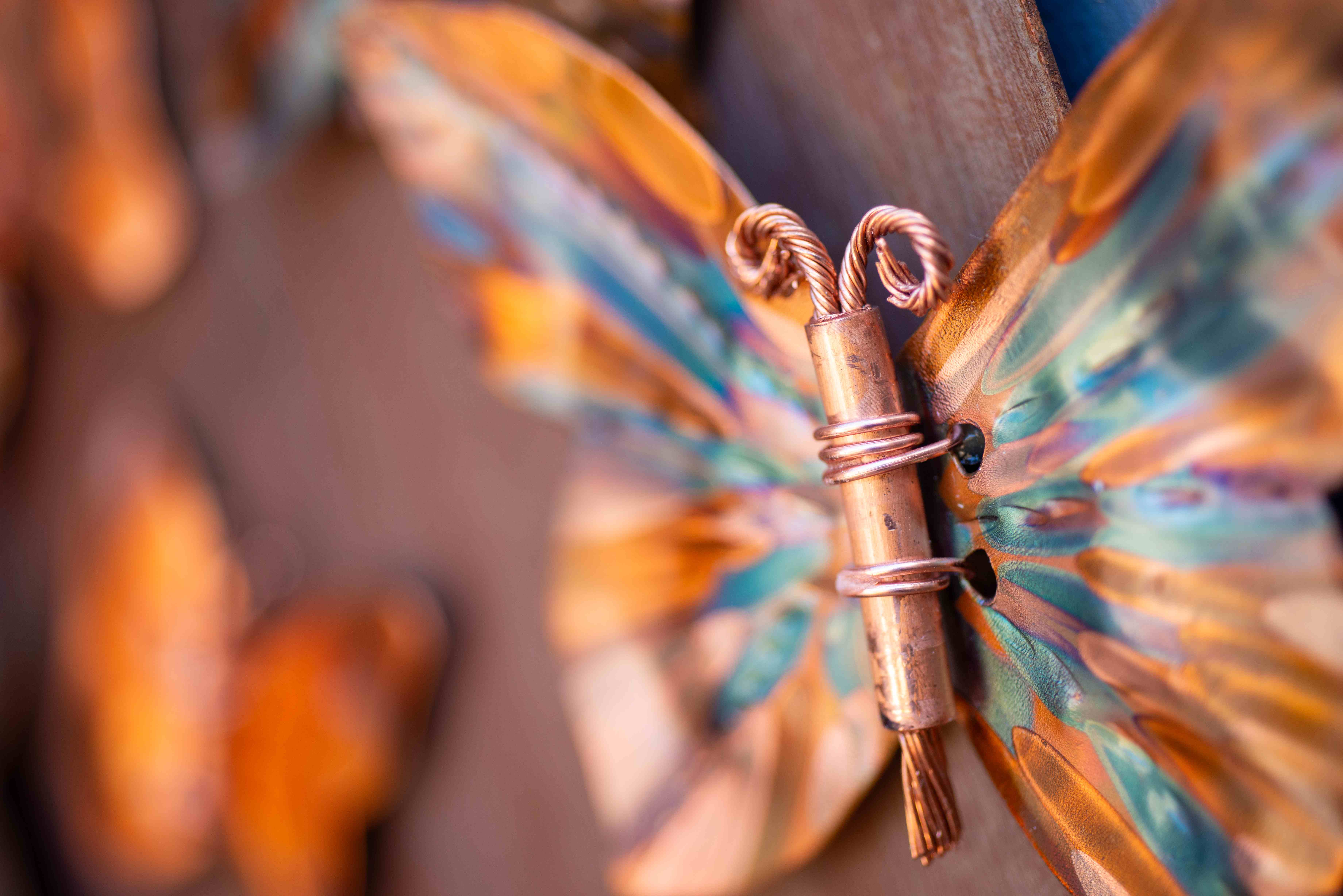 Detailed copper butterfly sculpture showing heat patina technique